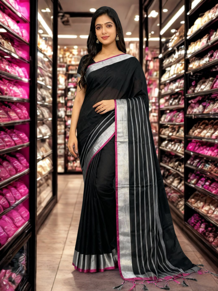 black handloom cotton silk saree featuring a distinct silver zari and magenta pink border.